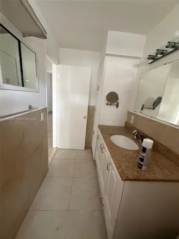 a bathroom with a sink and mirror