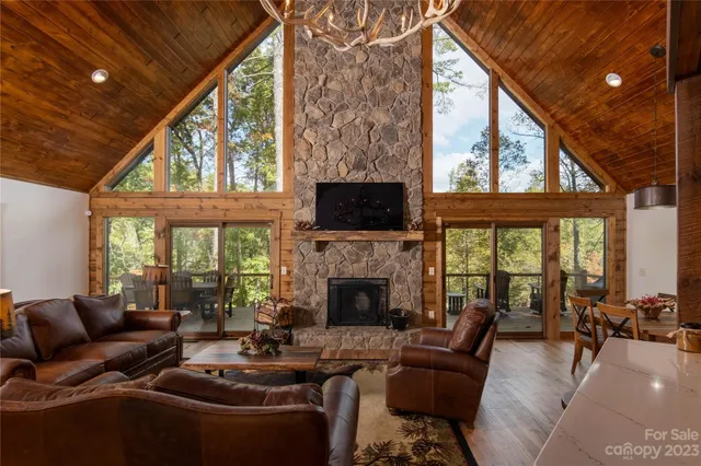 a living room with furniture a fireplace and a large window