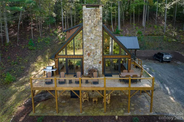 a view of house with swimming pool and outdoor seating