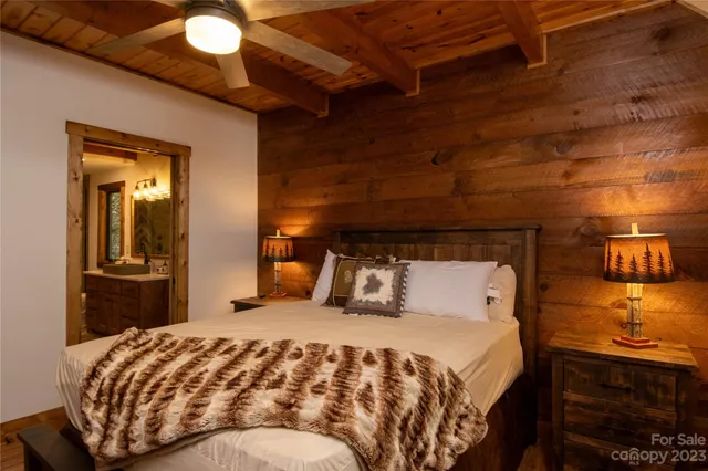 a bedroom with a bed and mirror