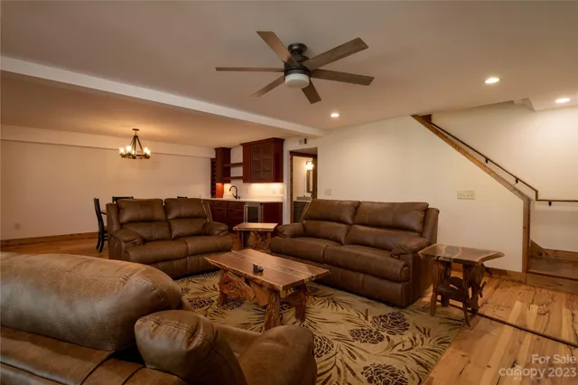 a living room with furniture and a ceiling fan