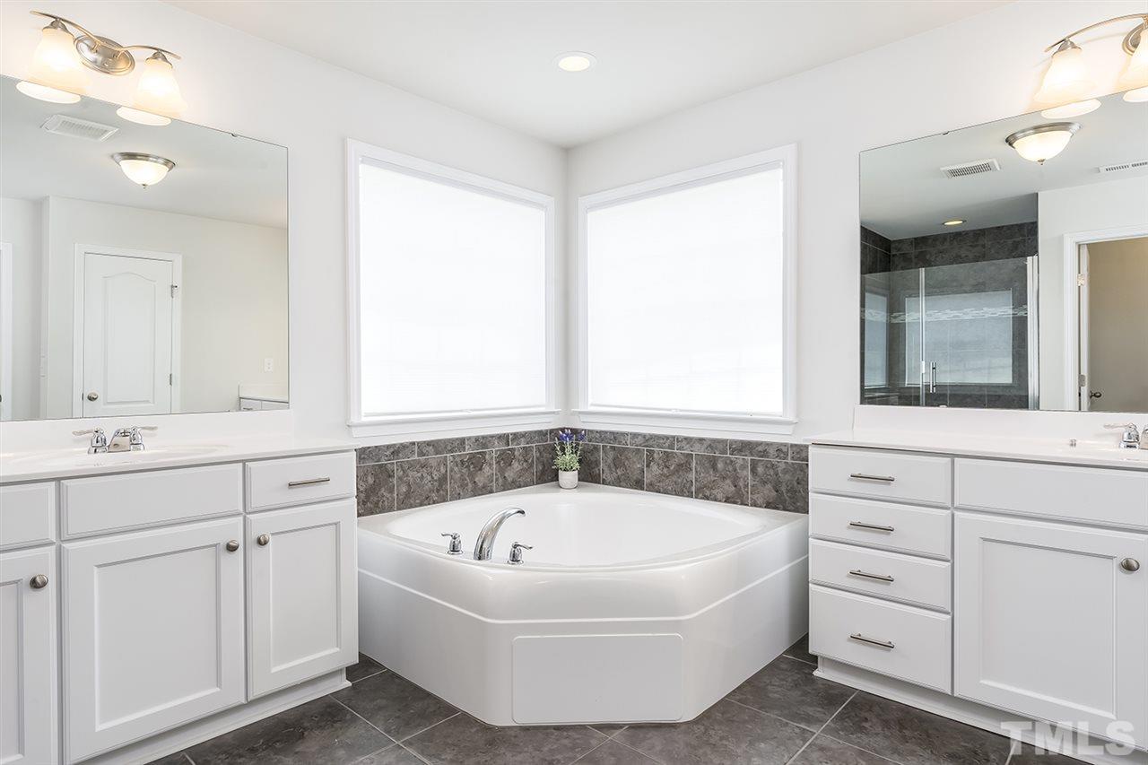 324 Morgan Ridge Road Holly Springs, NC 27540 - Photo 17 of 30 Garden Tub separates the Dual Vanities with Loads of Storage.