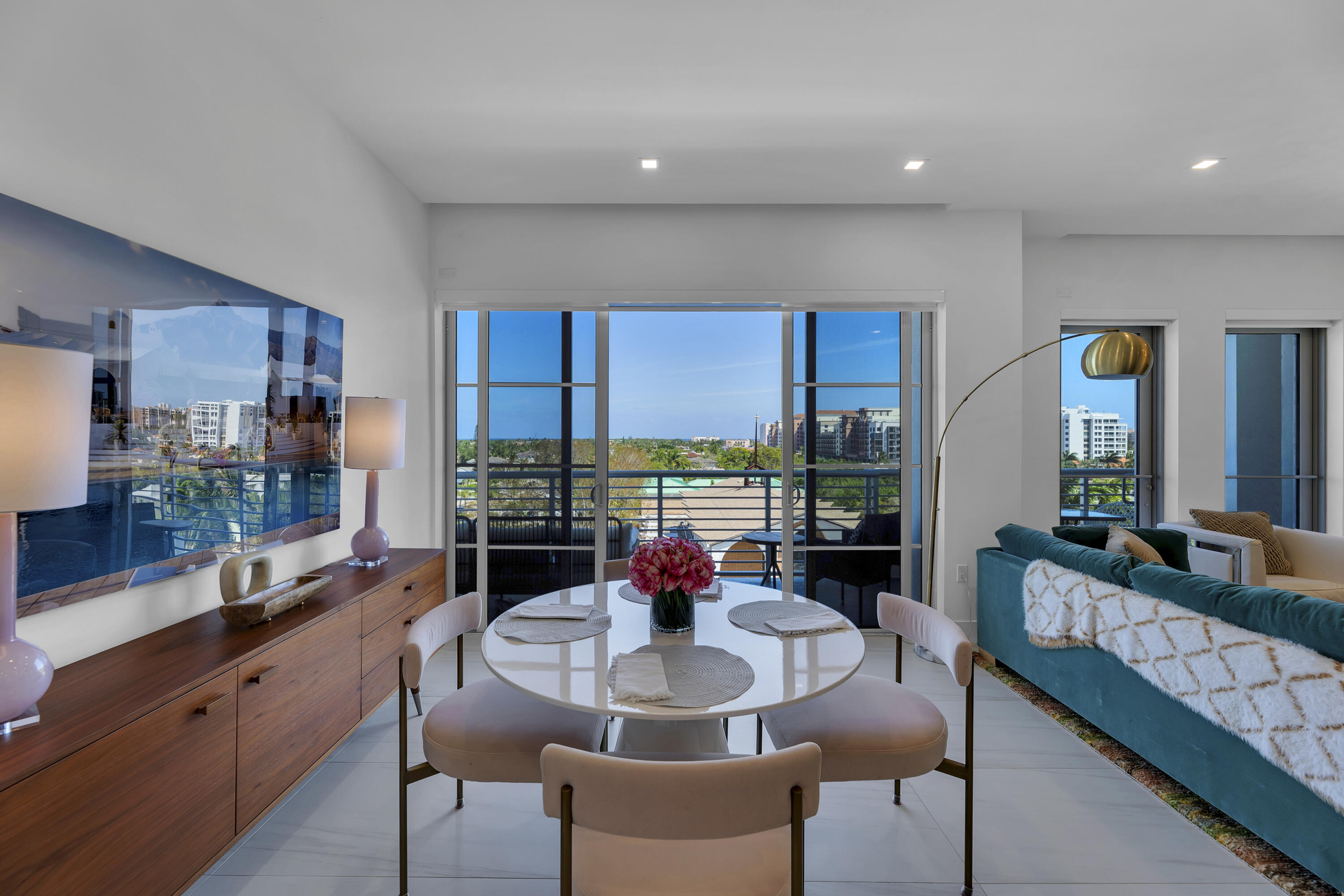 155 East Boca Raton Road, Unit 607 Boca Raton, FL 33432 - Photo 12 of 15 a dining room with furniture a large window and a chandelier