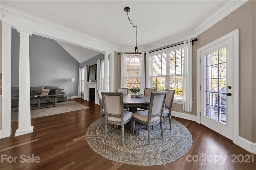 1804 Sam Smith Road Fort Mill, SC 29708 - Photo 14 of 48 a dining room with wooden floor a chandelier a wooden table and chairs