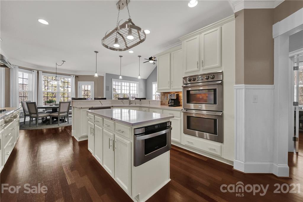 1804 Sam Smith Road Fort Mill, SC 29708 - Photo 23 of 48 a kitchen with stainless steel appliances a stove a sink and white cabinets
