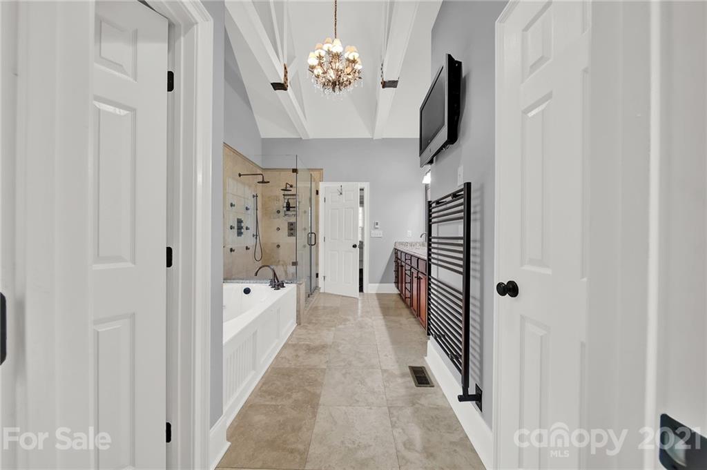 1804 Sam Smith Road Fort Mill, SC 29708 - Photo 34 of 48 a hallway with white doors wooden floor and staircase