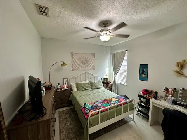 a bedroom with a bed gym equipment and a window