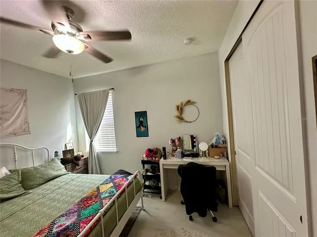 a bedroom with a bed gym equipment and a window