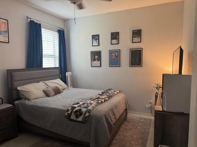 a bedroom with a bed and a window