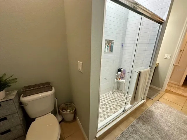 a bathroom with a toilet and shower
