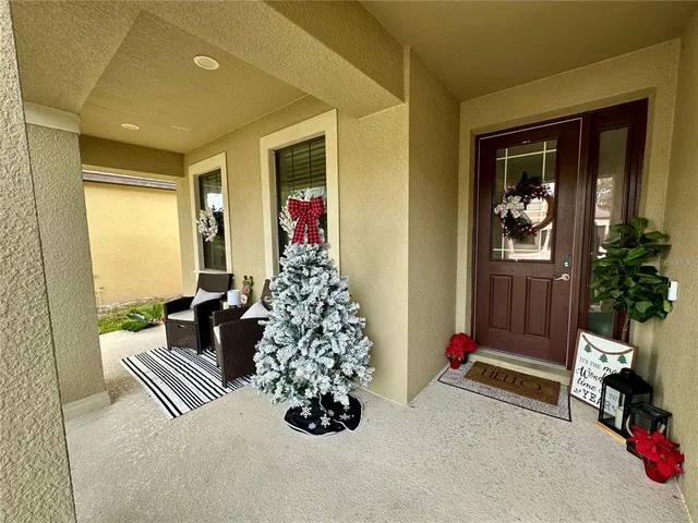 a living room with furniture and flowers