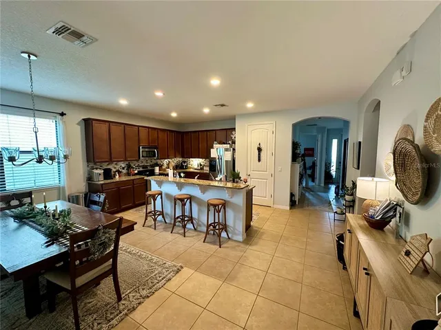 a kitchen with a dining table chairs and view kitchen