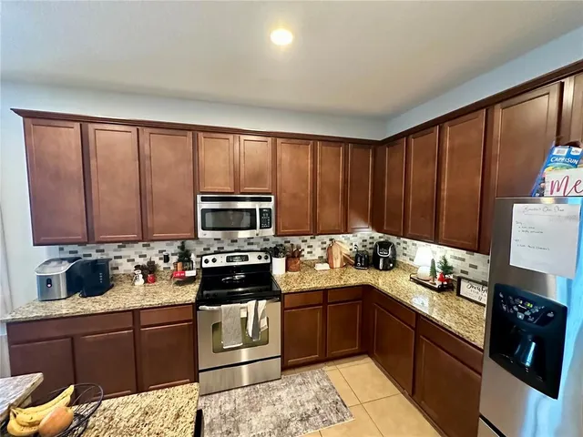 a kitchen with a sink stove and microwave