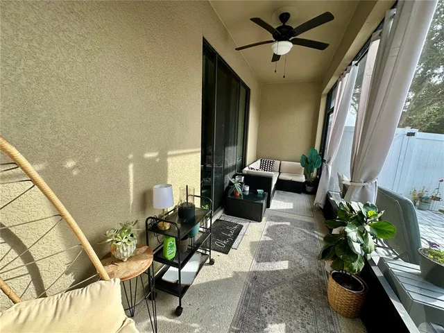 a living room with furniture flowerpot and a chandelier