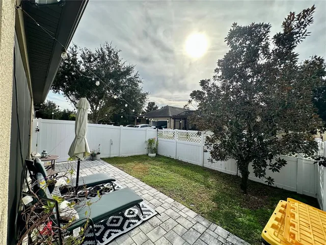 a view of a sink and yard with furniture