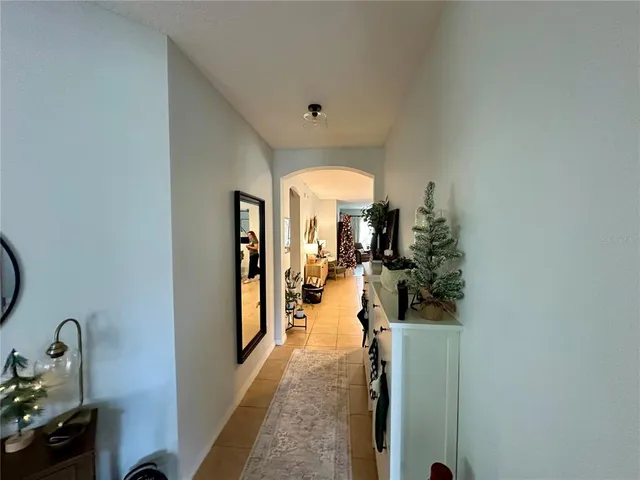 a view of a hallway with living room and furniture
