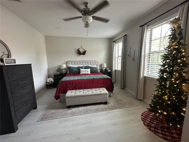 a bedroom with a bed dresser and a window