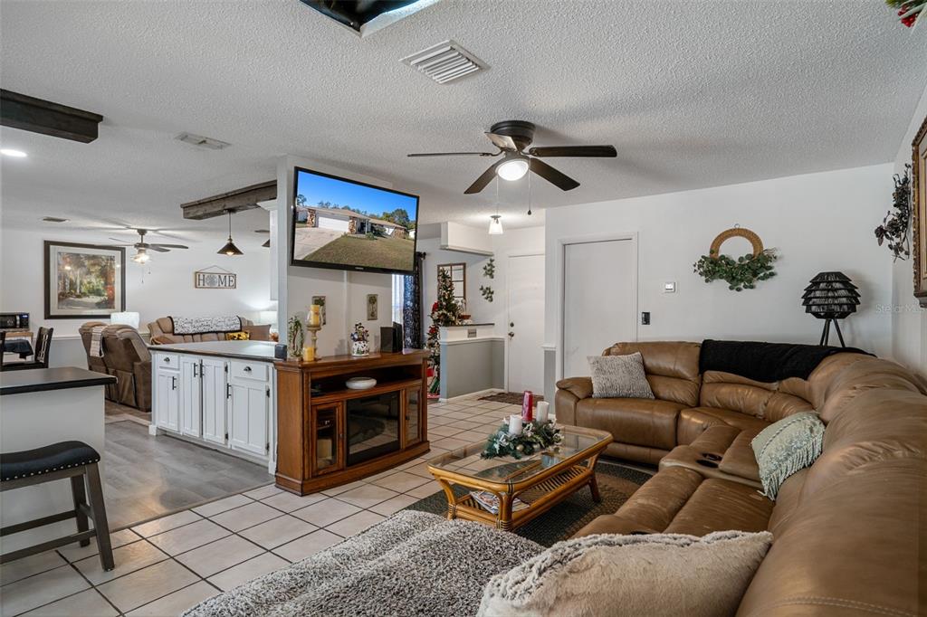 7311 Edinburgh Way Weeki Wachee, FL 34613 - Photo 12 of 27 a living room with furniture and wooden floor