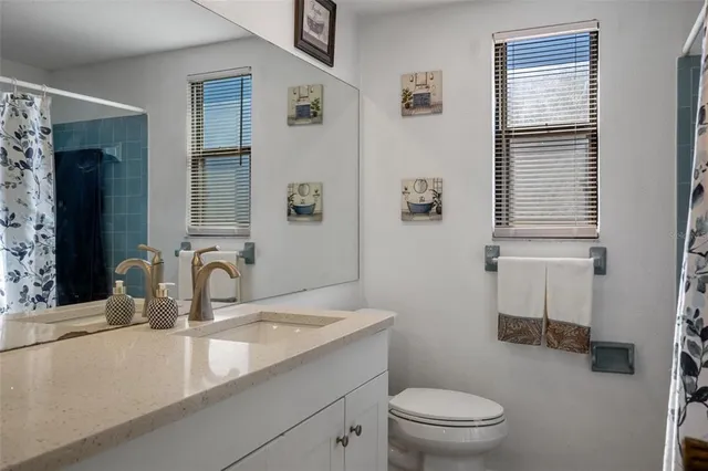 a bedroom with a bed chandelier and a window