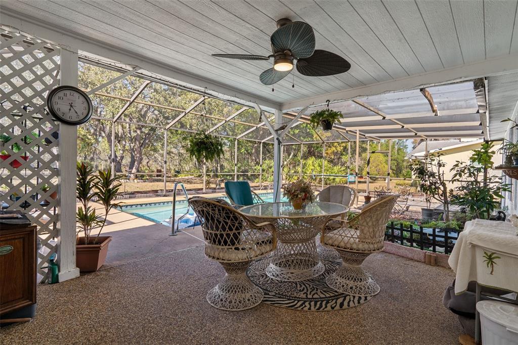 7311 Edinburgh Way Weeki Wachee, FL 34613 - Photo 22 of 27 a dining room with furniture and a large window