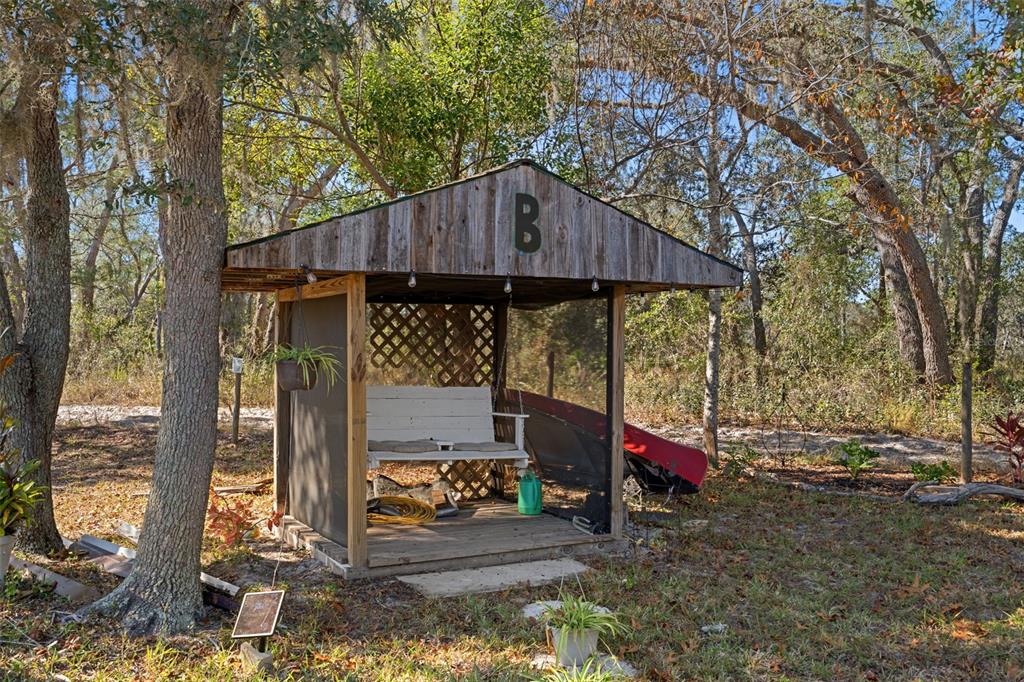 7311 Edinburgh Way Weeki Wachee, FL 34613 - Photo 26 of 27 a view of a wooden chairs and table in the back yard