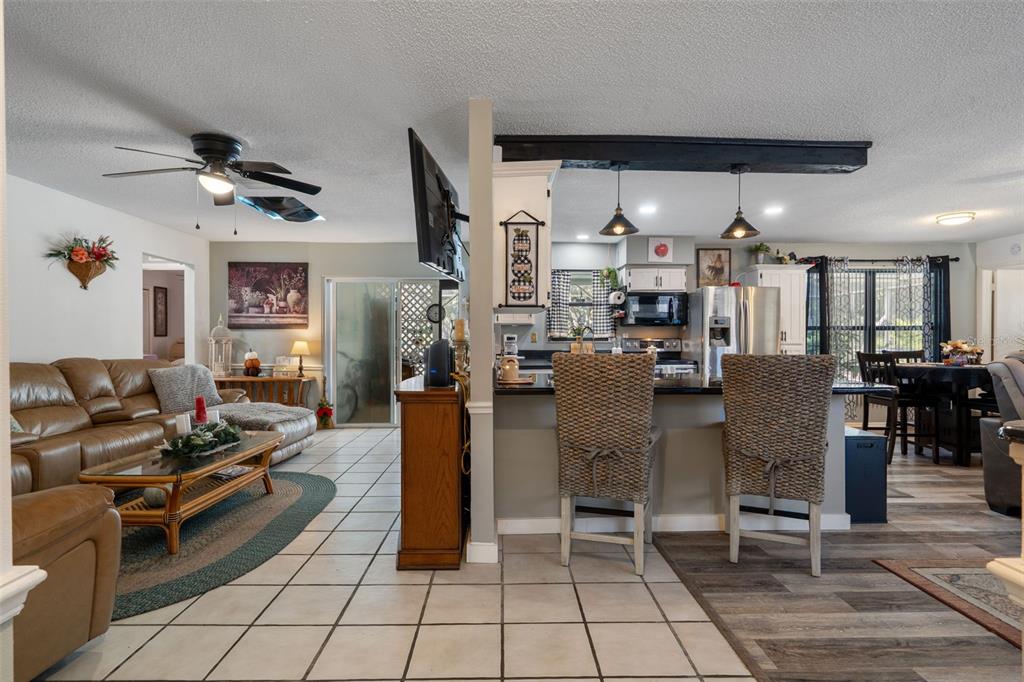 7311 Edinburgh Way Weeki Wachee, FL 34613 - Photo 6 of 27 a living room with lots of furniture and a clock