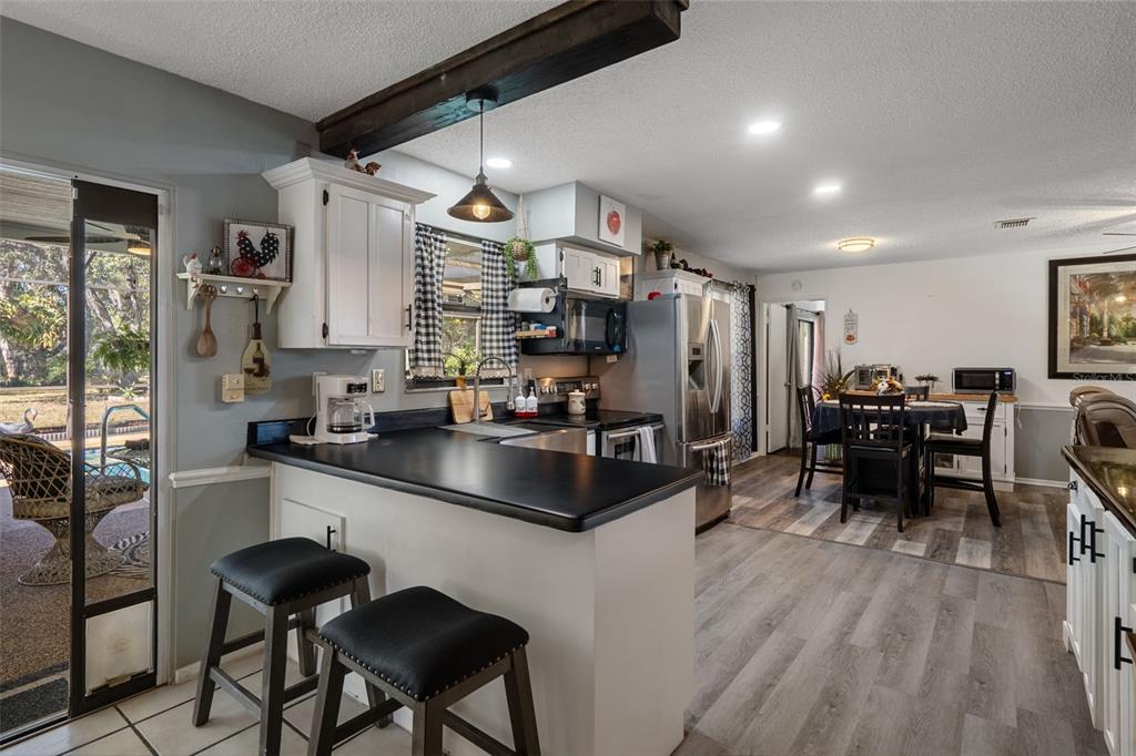 7311 Edinburgh Way Weeki Wachee, FL 34613 - Photo 8 of 27 a kitchen with sink cabinets and stainless steel appliances