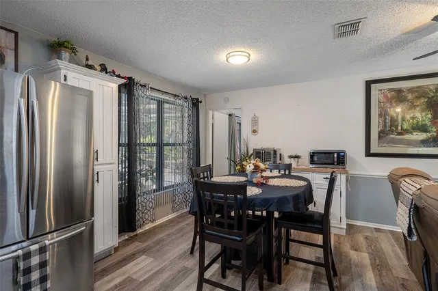 a view of a a dining room with furniture window and wooden floor