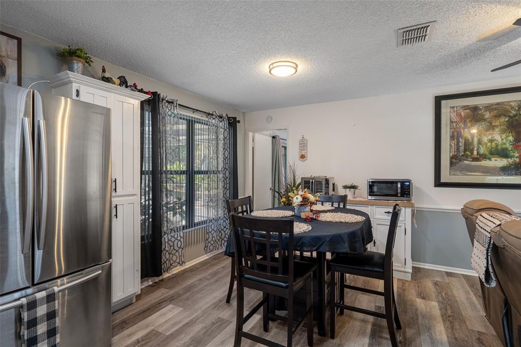 7311 Edinburgh Way Weeki Wachee, FL 34613 - Photo 9 of 27 a view of a dining room with furniture window and wooden floor