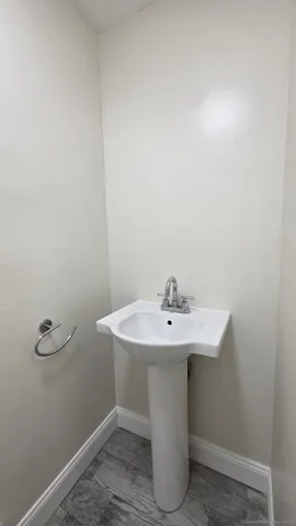 a bathroom with a sink a mirror and toilet
