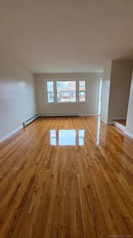 a view of an empty room and wooden floor