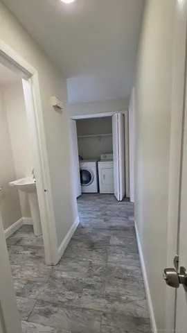 a view of an empty room and wooden floor