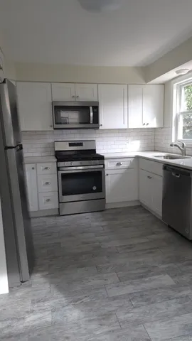 a kitchen with appliances cabinets and a sink