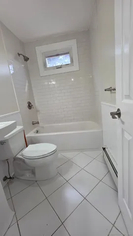 a bathroom with a toilet a sink and a shower