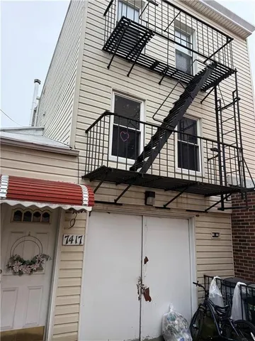 a view of a house with a balcony and stairs