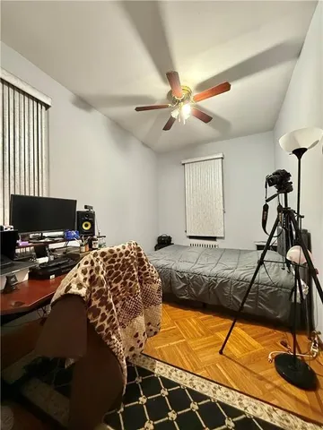 a bed room with a bed and a computer on the desk