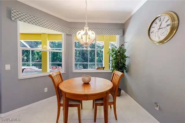 a dining room with furniture and a window
