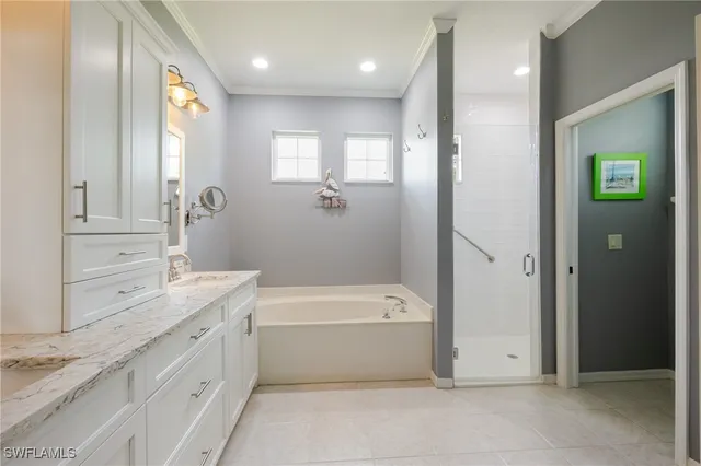 a bathroom with a tub a sink and mirror