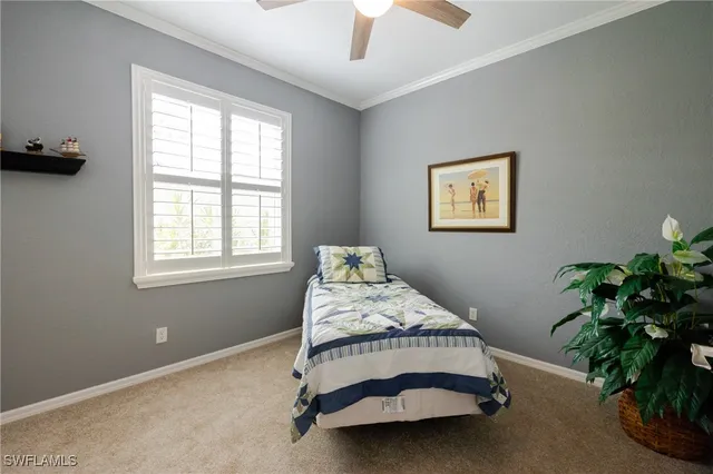 a bedroom with a bed and a potted plant