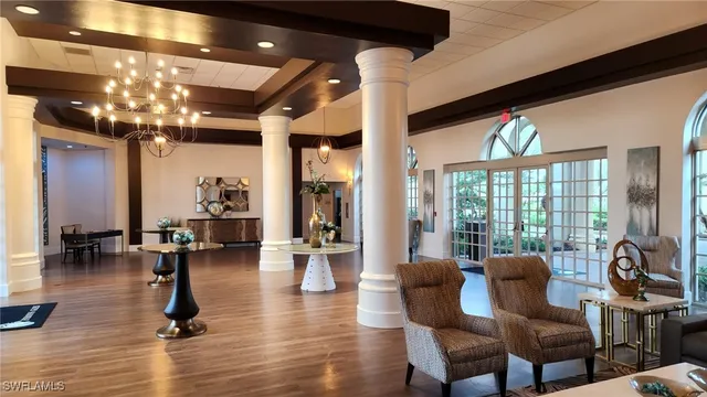 a living room with a table or chairs and a potted plant