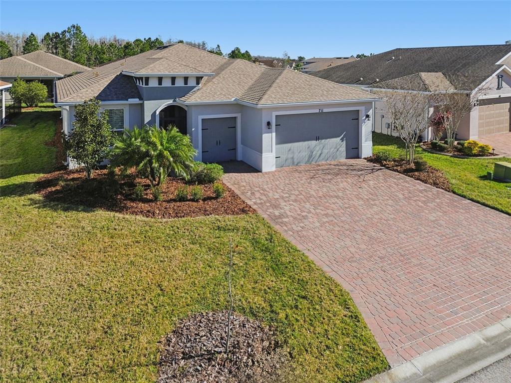 711 San Joaquin Road Kissimmee, FL 34759 - Photo 1 of 41 a front view of a house with a garden