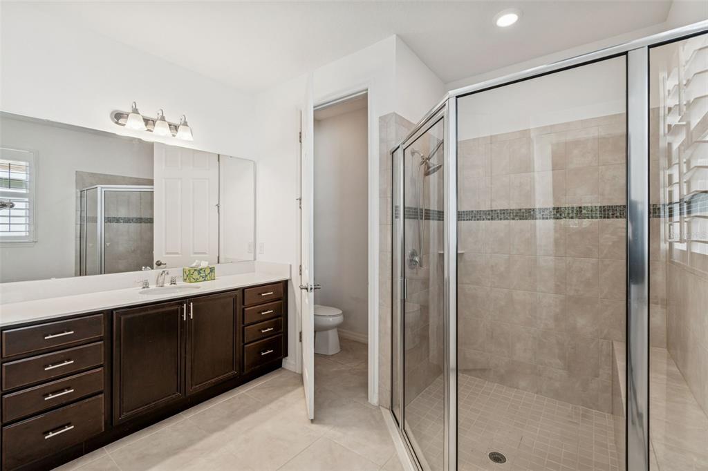 711 San Joaquin Road Kissimmee, FL 34759 - Photo 14 of 41 a bathroom with a double vanity sink and mirror