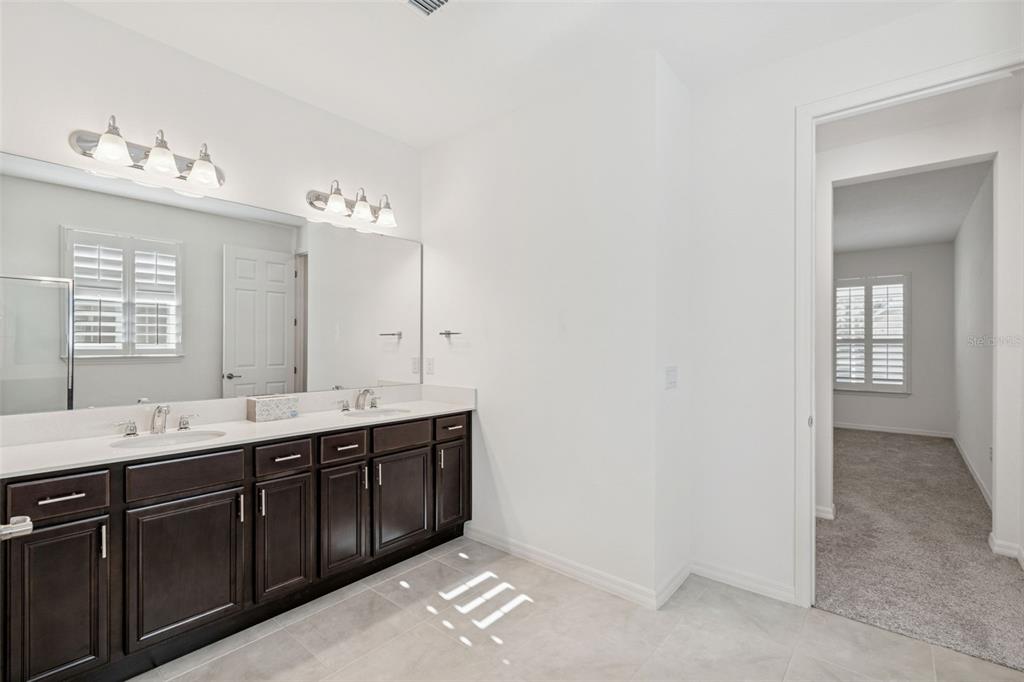 711 San Joaquin Road Kissimmee, FL 34759 - Photo 15 of 41 a spacious bathroom with a double vanity sink mirror and