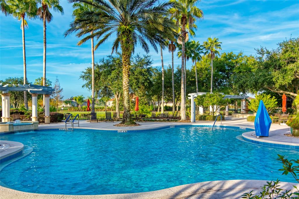711 San Joaquin Road Kissimmee, FL 34759 - Photo 32 of 41 a view of a swimming pool with a bench and trees