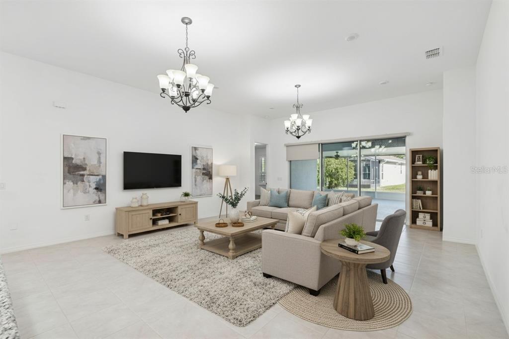711 San Joaquin Road Kissimmee, FL 34759 - Photo 5 of 41 a living room with furniture a chandelier and a flat screen tv