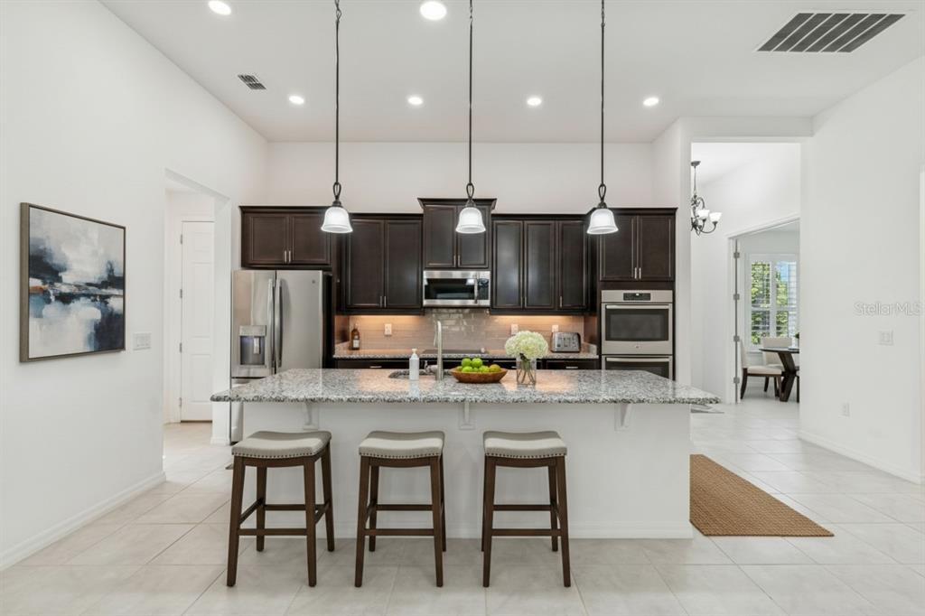 711 San Joaquin Road Kissimmee, FL 34759 - Photo 8 of 41 a large kitchen with a table and chairs