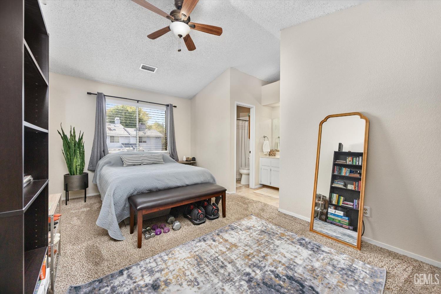 Undisclosed Address Bakersfield, CA 93311 - Photo 15 of 33 a bedroom with a bed a flat screen tv and dresser