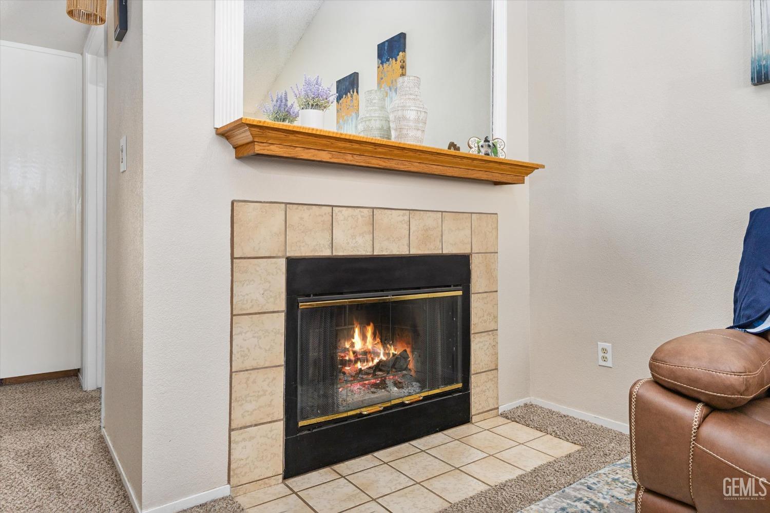 Undisclosed Address Bakersfield, CA 93311 - Photo 8 of 33 a fireplace with a clock on top of it