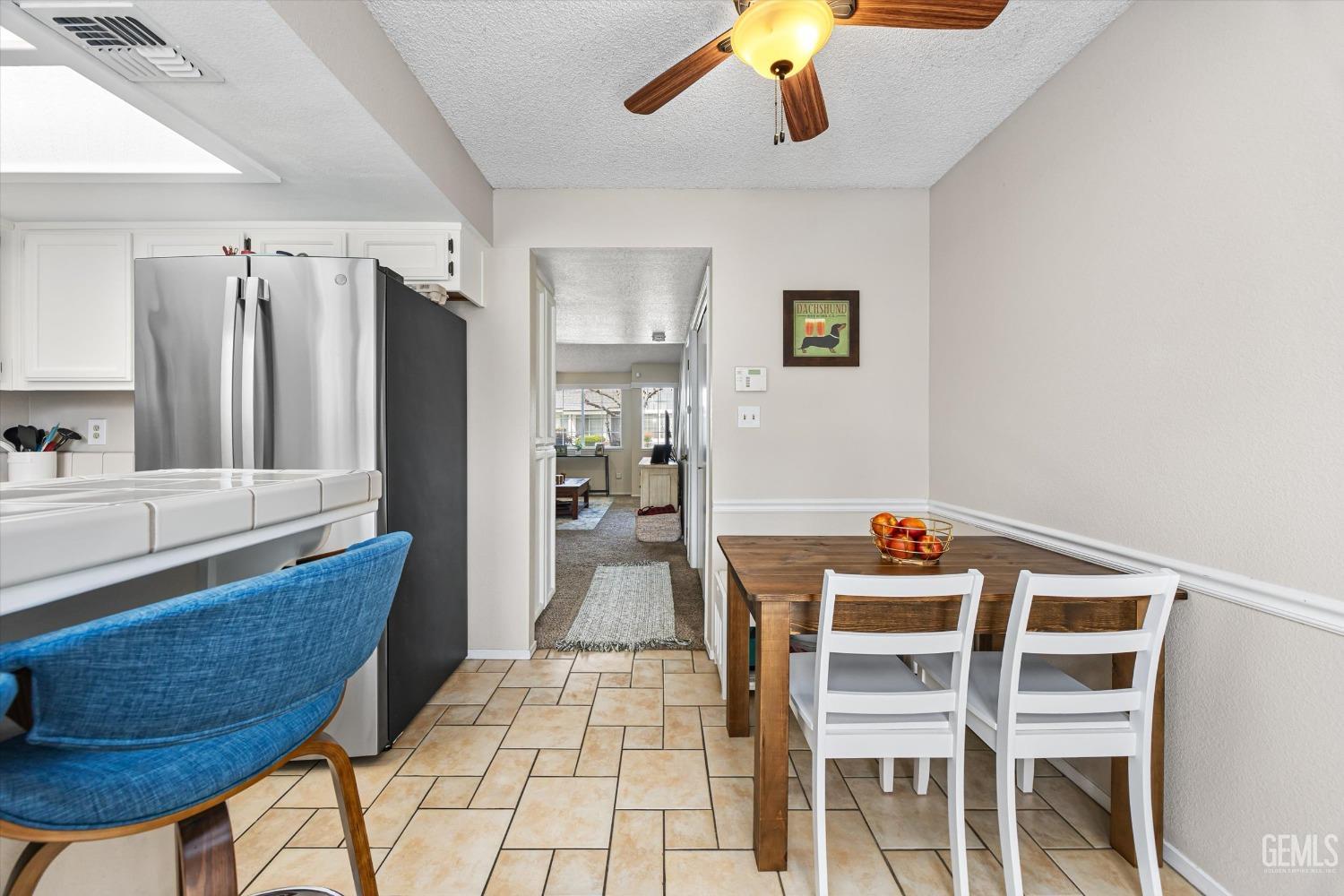 Undisclosed Address Bakersfield, CA 93311 - Photo 9 of 33 a dining room with furniture and a chandelier