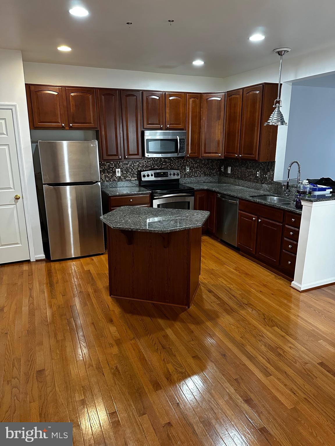 64 Monte Carlo Way Charles Town, WV 25414 - Photo 21 of 34 a kitchen with stainless steel appliances granite countertop a refrigerator a stove a sink a microwave and island